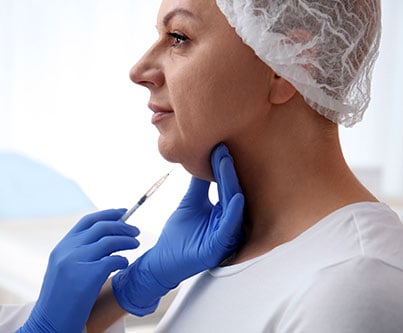 Woman receiving Kybella Injection in Neck for double chin