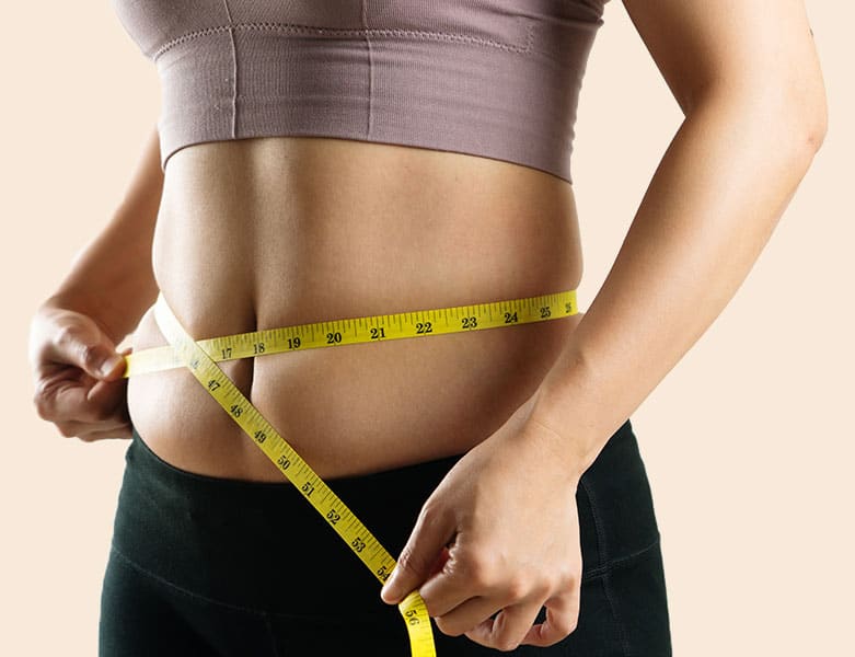 Woman measuring her waist, Before and after liposuction