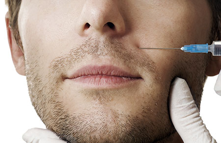 Man receiving dermal filler injection near mouth