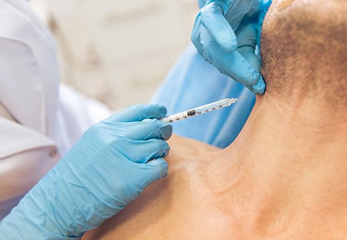 Man receiving Botox injection in neck