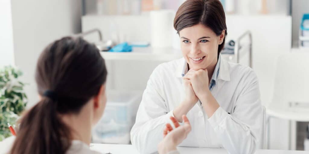 Doctor listening to patient during medical consultation